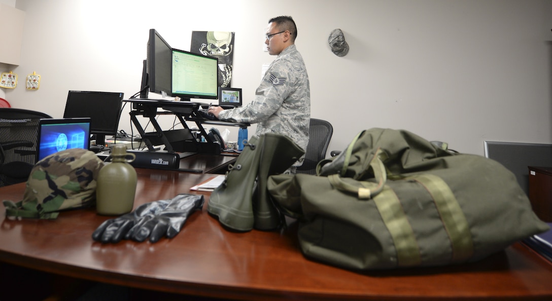 Staff Sgt. Jed Benedict P. Dauz, the 28th Comptroller Squadron and 28th Bomb Wing Staff unit deployment manager, lays equipment on his desk Aug. 14, 2017 on Ellsworth Air Force Base, S.D. Dauz has to take inventory of equipment to ensure that when Airmen deploy, they have the correct gear to accomplish their mission. (U.S. Air Force photo by Airman 1st Class Thomas Karol)