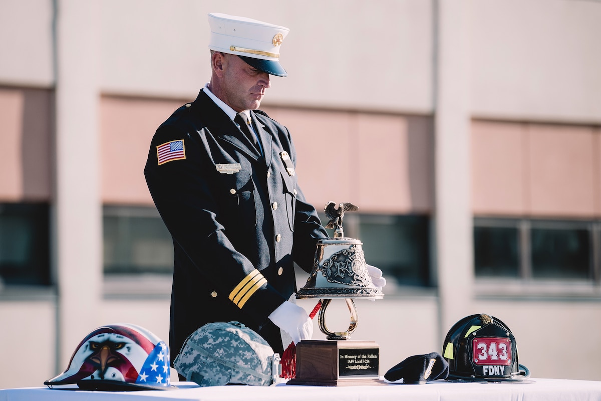 Joe Foucha, assistant chief of the Niagara Falls Air Reserve Station fire department, rings a bell in remembrance of those who lost their lives during the attacks on 9/11, Niagara Falls, N.Y., Sept. 11, 2017. New York Air National Guardsmen assigned to the 107th Attack Wing and 914th Air Refueling Wing attended the ceremony. Air National Guard photo by Staff Sgt. Ryan Campbell