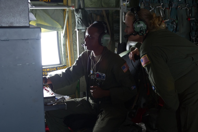 Photyo of Airmen inside a WC-130J Hurricane Hunter.