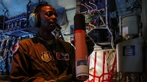 Air Force Reserve Tech. Sgt. Karen Moore, loadmaster, 53rd Weather Reconnaissance Squadron, Keesler Air Force Base, Mississippi, prepares a dropsonde to release into Hurricane Irma while flying into the hurricane, Sep. 8, 2017.