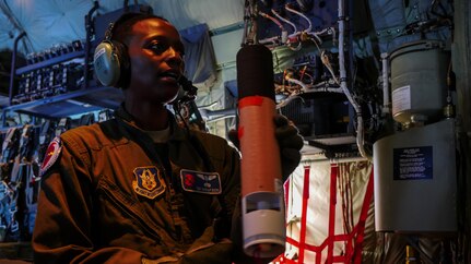 Air Force Reserve Tech. Sgt. Karen Moore, loadmaster, 53rd Weather Reconnaissance Squadron, Keesler Air Force Base, Mississippi, prepares a dropsonde to release into Hurricane Irma while flying into the hurricane, Sep. 8, 2017.