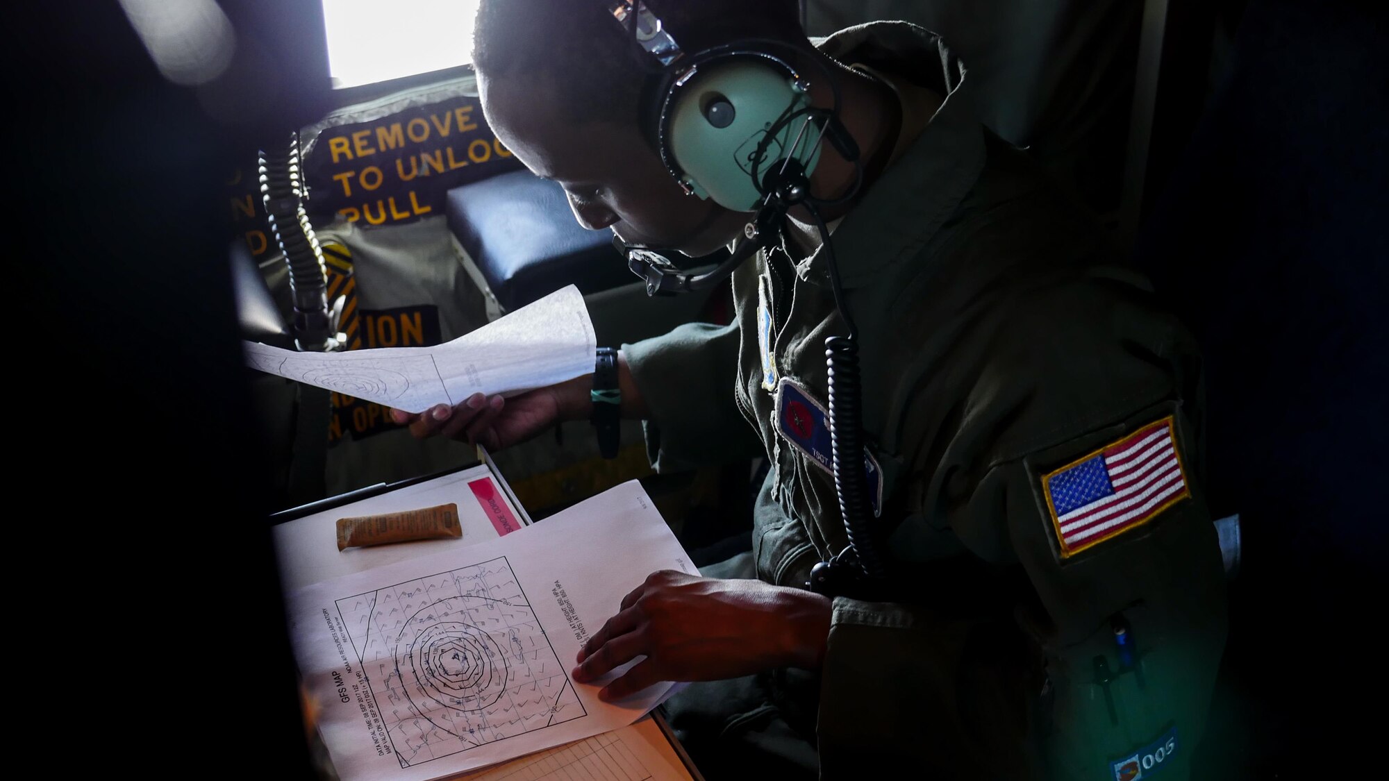 Air Force Reserve Tech. Sgt. Karen Moore, loadmaster, 53rd Weather Reconnaissance Squadron, Keesler Air Force Base, Mississippi, records weather information while flying into Hurricane Irma, Sep. 8, 2017.