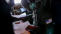 Air Force Reserve Tech. Sgt. Karen Moore, loadmaster, 53rd Weather Reconnaissance Squadron, Keesler Air Force Base, Mississippi, records weather information while flying into Hurricane Irma, Sep. 8, 2017.