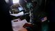 Air Force Reserve Tech. Sgt. Karen Moore, loadmaster, 53rd Weather Reconnaissance Squadron, Keesler Air Force Base, Mississippi, records weather information while flying into Hurricane Irma, Sep. 8, 2017.