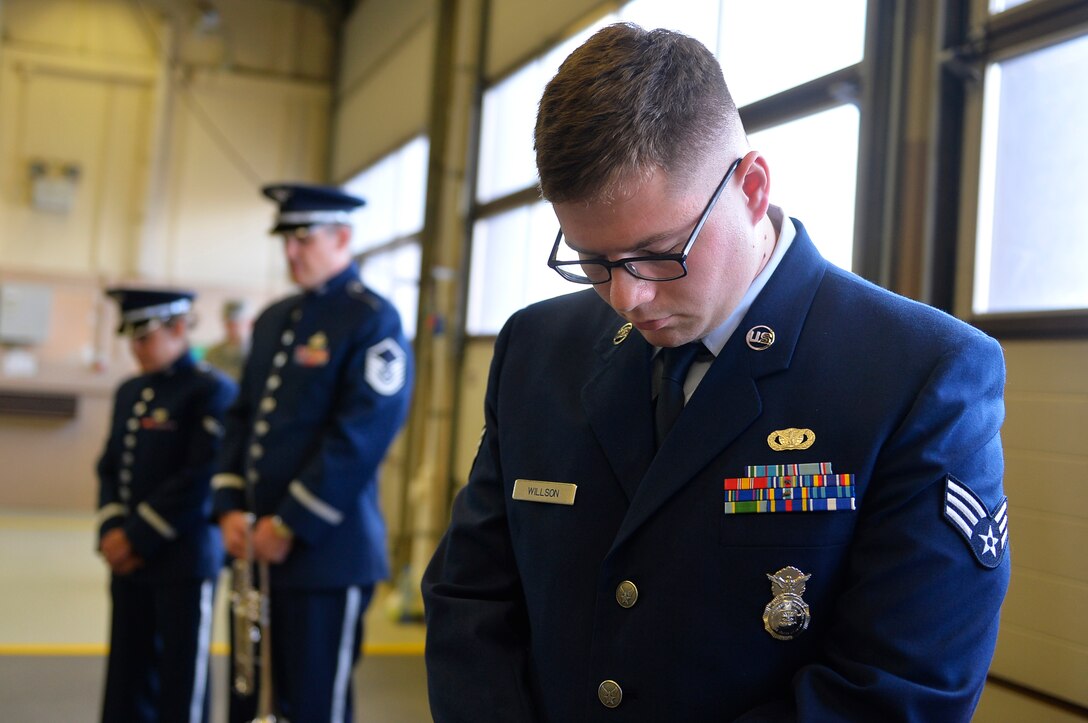 U.S. Airmen bow their heads in prayer during a 9/11 retreat ceremony on Ramstein Air Base, Germany, Sept. 11, 2017. The ceremony included a presentation of colors, speeches, a wreath laying and a ringing of the fire bell. (U.S. Air Force photo by Airman 1st Class Joshua Magbanua)