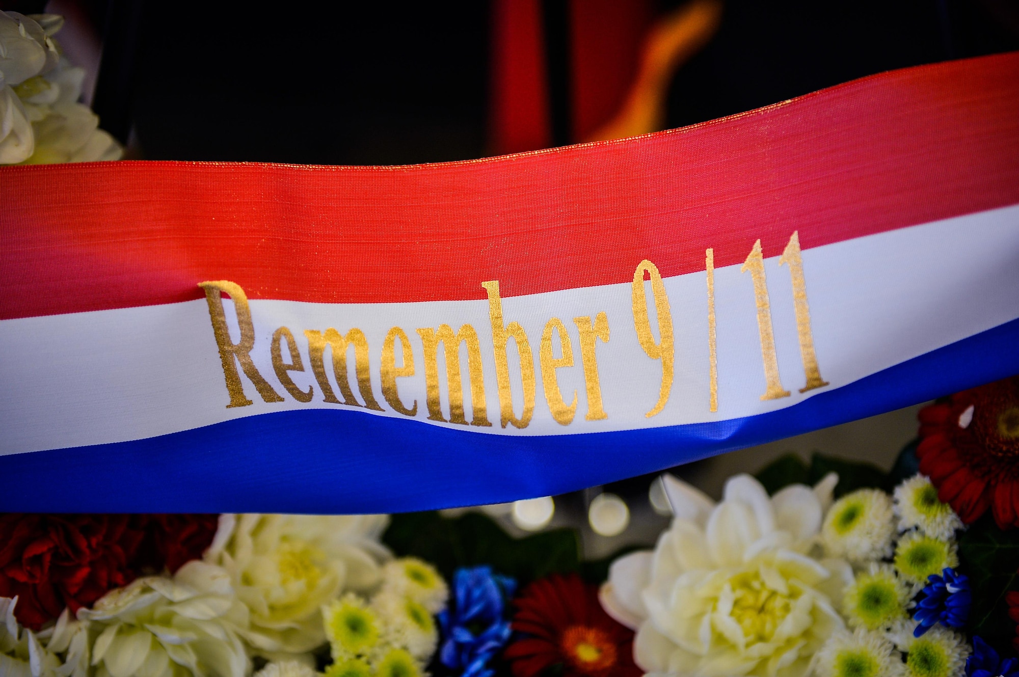 A ribbon on a wreath displays the words “Remember 9/11” during a retreat ceremony on Ramstein Air Base, Germany, Sept. 11, 2017. The ceremony marked 16 years since the attacks on the World Trade Center, the Pentagon, and the hijacking of United Airlines flight 93. (U.S. Air Force photo by Airman 1st Class Joshua Magbanua)