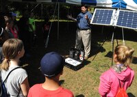 Mark Thompson, U.S. Army Engineering and Support Center, Huntsville public affairs specialist, explains the technology behind solar panels and the importance of renewable energy to students from Horizon Elementary School. More than 150 fifth-grade students from Horizon and Monte Sano elementary schools celebrated Earth Day April 20 at the Path to Nature on Redstone Arsenal.