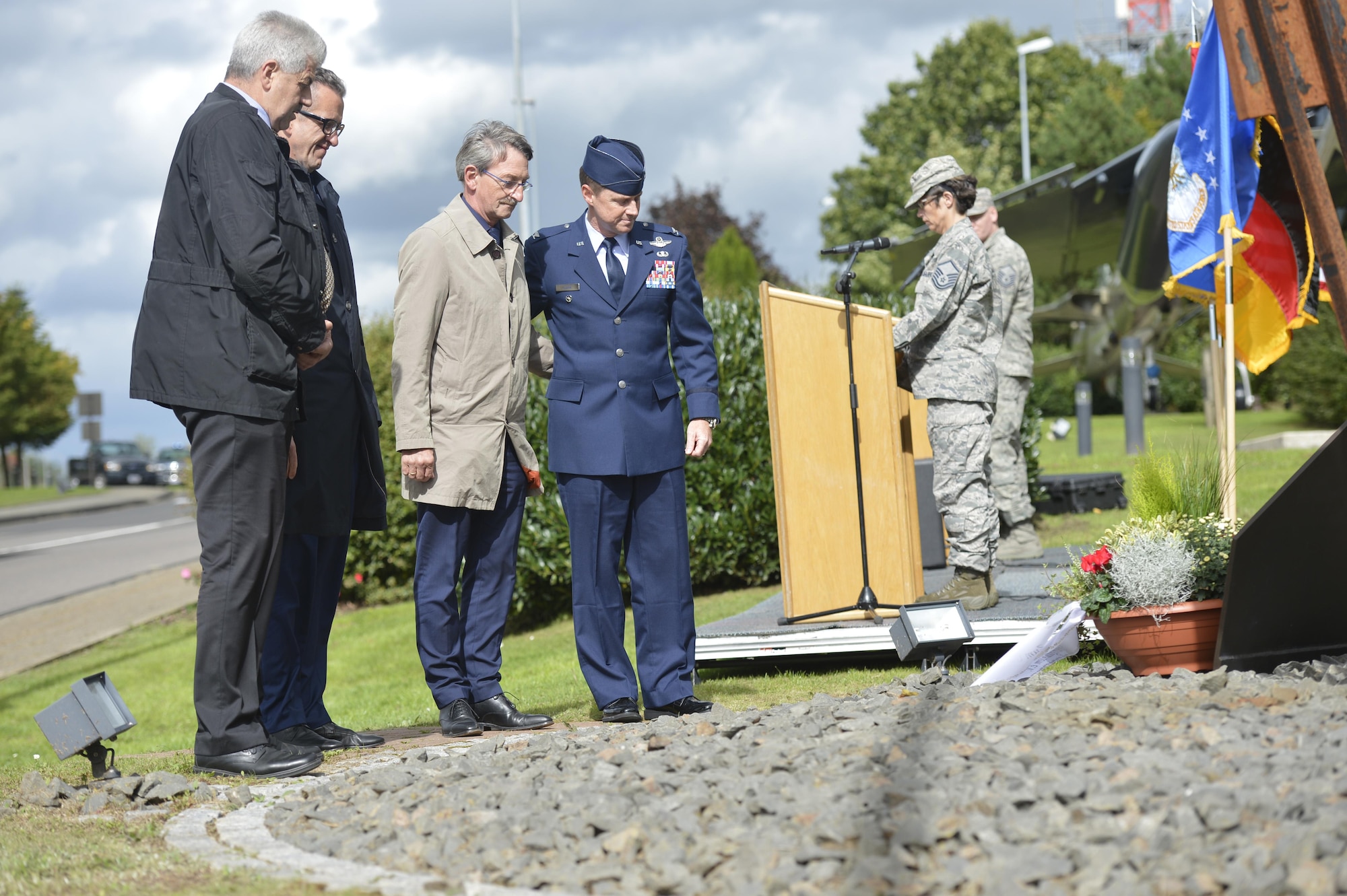 U.S. Air Force Col. Tad Clark, 52nd Fighter Wing vice commander, and prominent members of the local community place a flower arrangement at the 9/11 memorial at the air park on Spangdahlem Air Base, Germany, September 11, 2017. Ceremonies throughout the Air Force and around the world took place to commemorate the 16th anniversary of the attacks on 9/11. (U.S. Air Force photo by Tech. Sgt. Chad Warren)