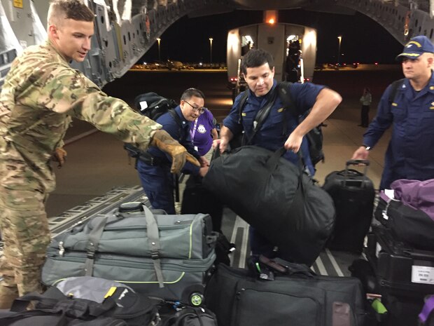 Staff Sgt. Rob Lummus, 15th Airlift Squadron loadmaster, helps medical professionals from Health and Human Services load baggage on a flight from Dulles International  Airport, Washington D.C., to Orlando, Florida, Sept. 9. The mission supported HHS as they coordinate the federal medical and public health medical support to the state of  Florida. Lummus' first exposure to a C-17 came when he was 17-years old volunteering during Hurricane Katrina.
