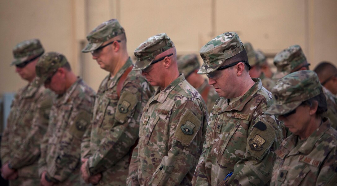 Airmen pause for a moment of silence during a 9/11 remembrance ceremony.