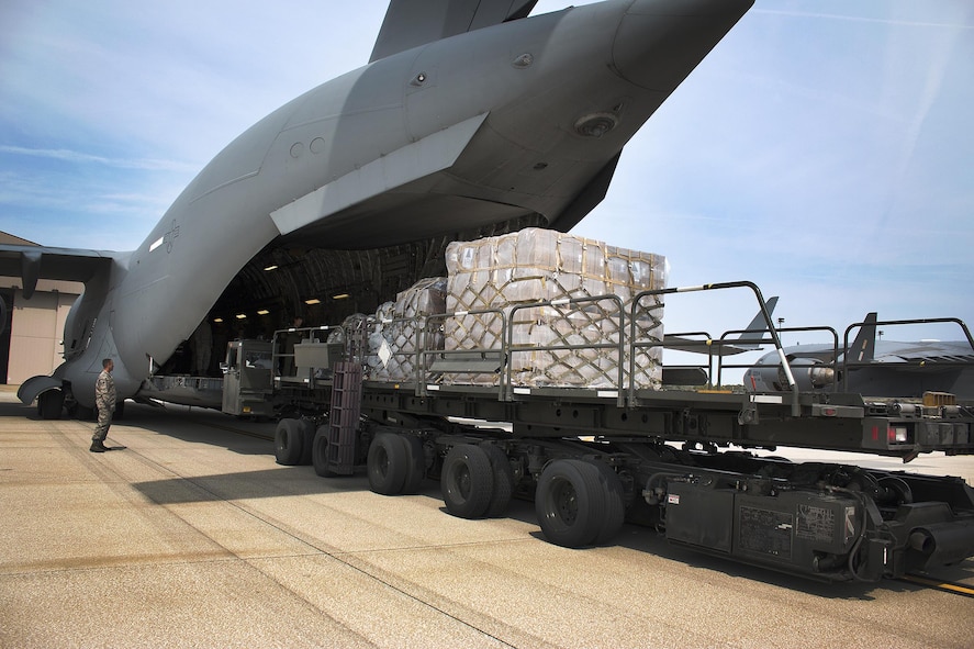 Airmen from the 87th Aerial Port Squadron load cargo onto a 445th Airlift Wing C-17 Globemaster III headed for Homestead Air Reserve Base, Florida Monday. Cargo included a pallet of meals ready to eat, a pallet of water and one ISU 90 loaded with cots. (U.S. Air Force photo/Master Sgt. Patrick O’Reilly)