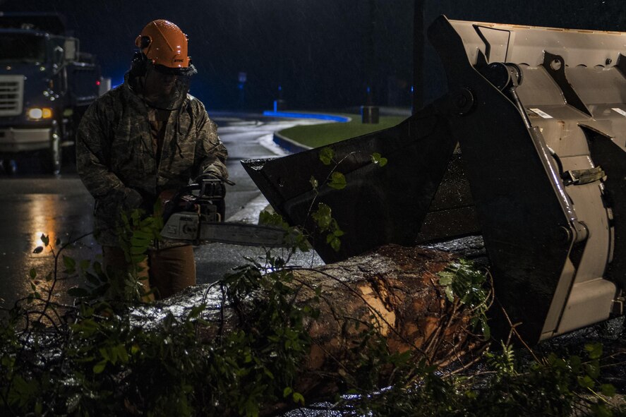 Senior Airman Justin Benito, 23rd Civil Engineer Squadron heavy equipment operator, uses a chainsaw to cut a fallen tree’s trunk, Sept. 11, 2017, at Moody Air Force Base, Ga. Moody’s ride-out team consisted of approximately 80 Airmen who were tasked with immediately responding to mission-inhibiting damage caused by Hurricane Irma. (U.S. Air Force photo by Airman 1st Class Daniel Snider)