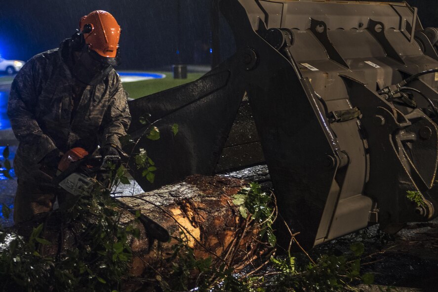 Senior Airman Justin Benito, 23rd Civil Engineer Squadron heavy equipment operator, uses a chainsaw to cut a fallen tree’s trunk, Sept. 11, 2017, at Moody Air Force Base, Ga. Moody’s ride-out team consisted of approximately 80 Airmen who were tasked with immediately responding to mission-inhibiting damage caused by Hurricane Irma. (U.S. Air Force photo by Airman 1st Class Daniel Snider)