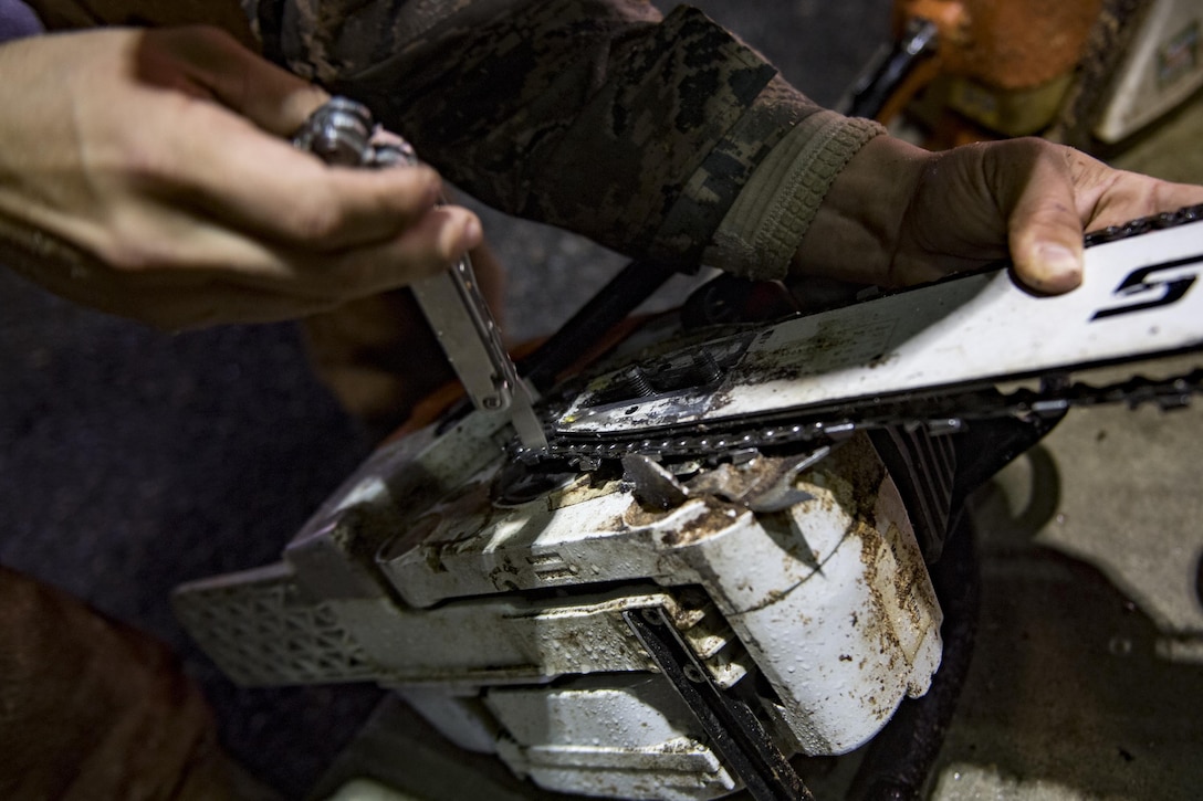 Senior Airman Justin Benito, 23rd Civil Engineer Squadron heavy equipment operator, repairs a chainsaw, Sept. 11, 2017, at Moody Air Force Base, Ga. Moody’s ride-out team consisted of approximately 80 Airmen who were tasked with immediately responding to mission-inhibiting damage caused by Hurricane Irma. (U.S. Air Force photo by Airman 1st Class Daniel Snider)