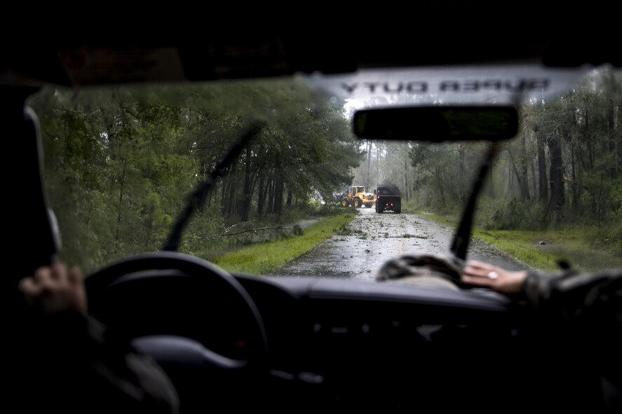 Members of Moody’s ride-out team slow their vehicle behind 23rd Civil Engineer Squadron heavy equipment operators, Sept. 11, 2017, at Moody Air Force Base, Ga. Moody’s ride-out team consisted of approximately 80 Airmen who were tasked with immediately responding to mission-inhibiting damage caused by Hurricane Irma. (U.S. Air Force photo by Airman 1st Class Daniel Snider)