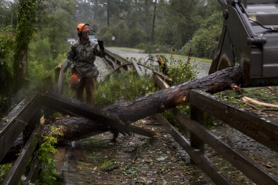 Senior Airman Justin Benito, 23rd Civil Engineer Squadron heavy equipment operator, uses a chainsaw to cut a fallen tree’s trunk, Sept. 11, 2017, at Moody Air Force Base, Ga. Moody’s ride-out team consisted of approximately 80 Airmen who were tasked with immediately responding to mission-inhibiting damage caused by Hurricane Irma. (U.S. Air Force photo by Airman 1st Class Daniel Snider)