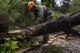Senior Airman Justin Benito, 23rd Civil Engineer Squadron heavy equipment operator, uses a chainsaw to cut a fallen tree’s trunk, Sept. 11, 2017, at Moody Air Force Base, Ga. Moody’s ride-out team consisted of approximately 80 Airmen who were tasked with immediately responding to mission-inhibiting damage caused by Hurricane Irma. (U.S. Air Force photo by Airman 1st Class Daniel Snider)