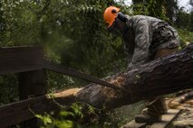 Senior Airman Justin Benito, 23rd Civil Engineer Squadron heavy equipment operator, uses a chainsaw to cut a fallen tree’s trunk, Sept. 11, 2017, at Moody Air Force Base, Ga. Moody’s ride-out team consisted of approximately 80 Airmen who were tasked with immediately responding to mission-inhibiting damage caused by Hurricane Irma. (U.S. Air Force photo by Airman 1st Class Daniel Snider)