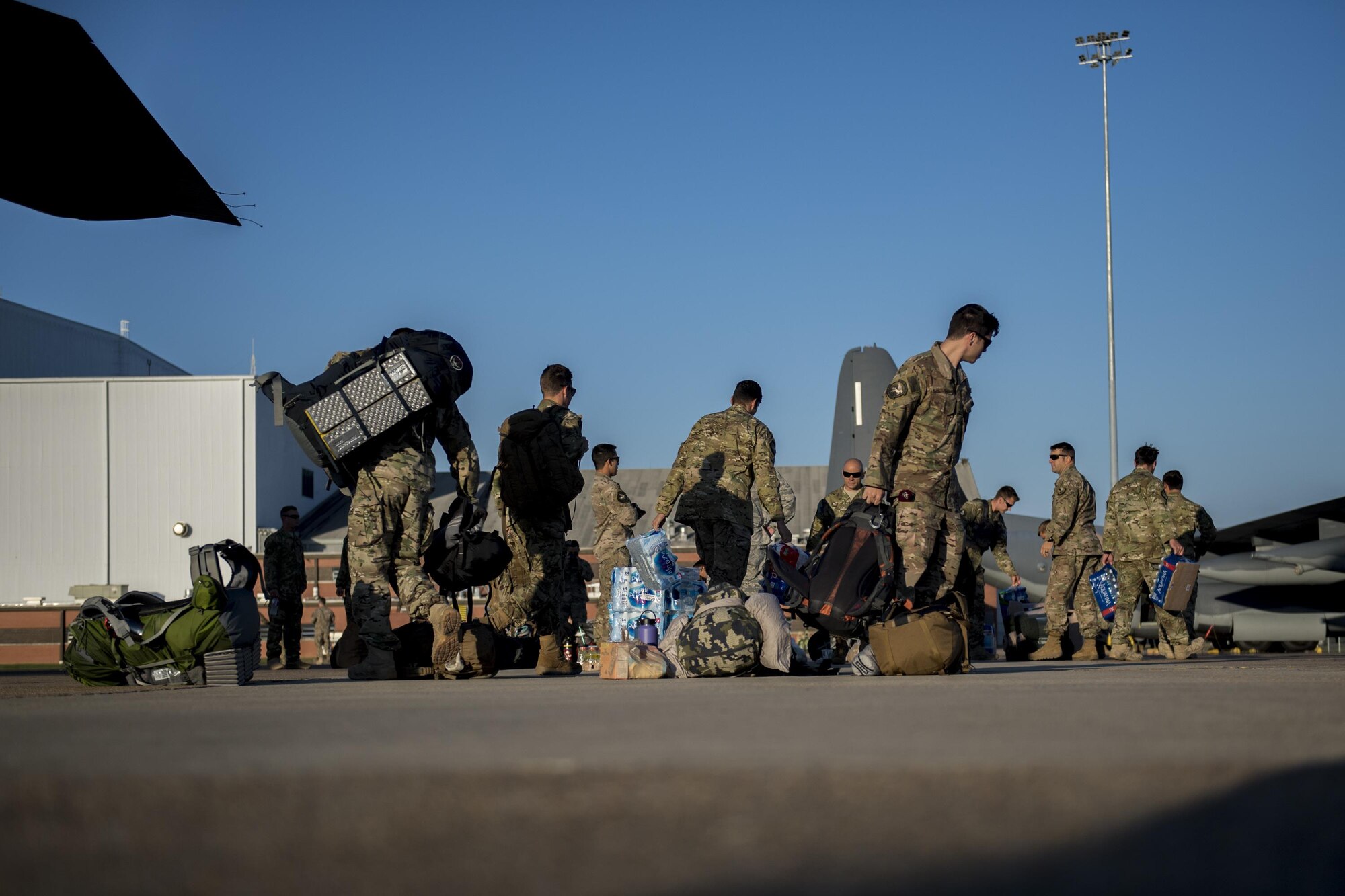 Members of the 563d Rescue Group move their gear prior to boarding an HC-130J Combat King II, Sept. 11, 2017, at Jackson-Medgar Wiley Evers Air National Guard Base, Miss. Aircraft and personnel from the 563d Rescue Group mobilized to Homestead ARB to assist in rescue efforts after Hurricane Irma made landfall. The 563d RQG is supporting FEMA’s disaster response efforts. (U.S. Air Force photo by Tech. Sgt. Zachary Wolf)