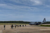 Members of the 563d Rescue Group walk towards an HC-130J Combat King II, Sept. 11, 2017, at Jackson-Medgar Wiley Evers Air National Guard Base, Miss. Aircraft and personnel from the 563d Rescue Group mobilized to Homestead ARB to assist in rescue efforts after Hurricane Irma made landfall. The 563d RQG is supporting FEMA’s disaster response efforts. (U.S. Air Force photo by Tech. Sgt. Zachary Wolf)