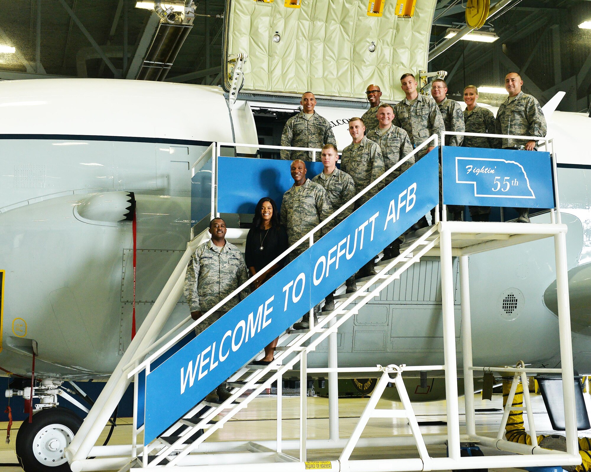 Chief Master Sgt. of the Air Force Kaleth O. Wright and his wife, Tonya Wright, pose for a photo in front of an RC-135 Rivet Joint reconnaissance aircraft with some Team Offutt members inside the Bennie Davis Maintenance Facility on Offutt Air Force Base, Nebraska, Aug. 31, 2017.