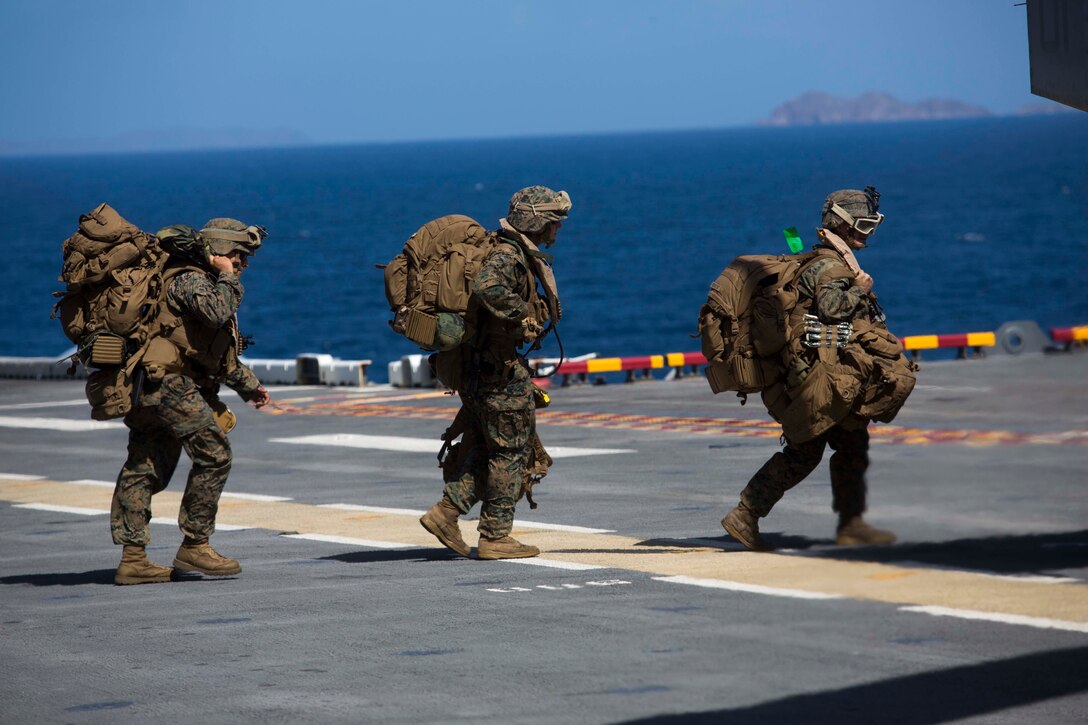 U.S. Marines with Battalion Landing Team 2nd Battalion, 6th Marine Regiment, 26th Marine Expeditionary Unit (MEU), prepare to board an MV-22 Osprey aircraft to provide relief efforts in the U.S. Virgin Islands aboard the amphibious assault ship USS Kearsarge (LHD 3), in the Caribbean Sea, Sept. 11, 2017. The 26th MEU is supporting the lead federal agency in providing humanitarian relief (and/or search and rescue) efforts for Hurricane Irma. (U.S. Marine Corps photo by Lance Cpl. Santino D. Martinez)