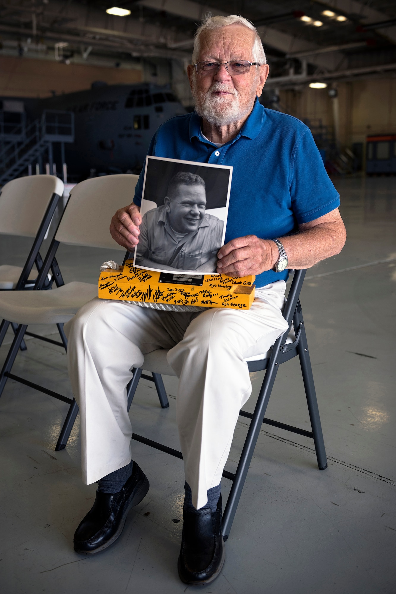 Retired U.S. Air Force Chief Master Sgt. Homer Wells, a former chief of maintenance with the 182nd Tactical Air Support Group, poses with a portrait of himself after a ceremony honoring his service in Peoria, Ill., Aug. 24, 2017. Wells enlisted in 1947 and retired in 1984 with 37 years of service with the Illinois Air National Guard. (U.S. Air National Guard photo by Tech. Sgt. Lealan Buehrer)