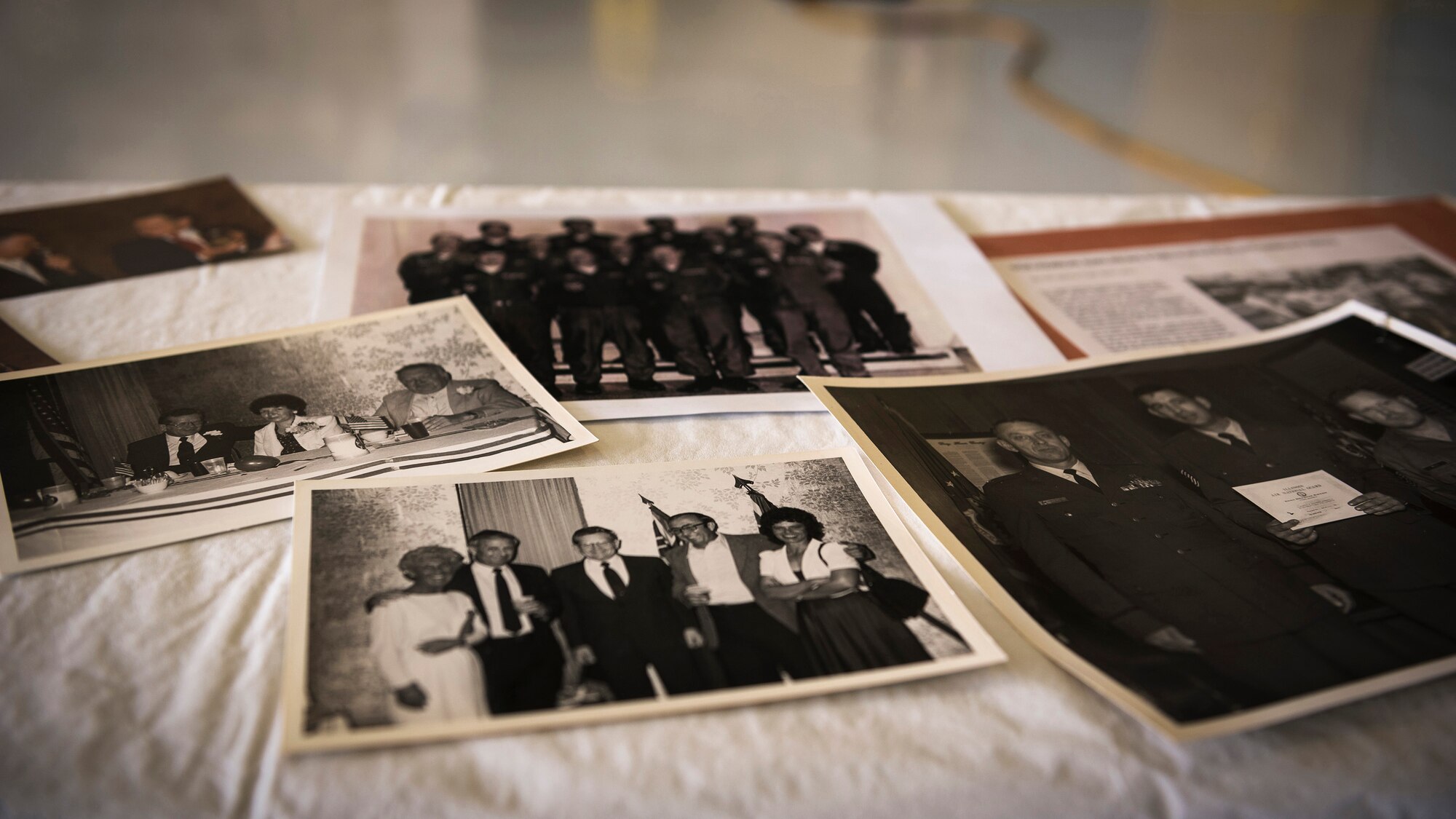 Historical photos of retired U.S. Air Force Chief Master Sgt. Homer Wells, a former chief of maintenance with the 182nd Tactical Air Support Group, are pictured prior to a ceremony honoring his service in Peoria, Ill., Aug. 24, 2017. Wells enlisted in 1947 and retired in 1984 with 37 years of service with the Illinois Air National Guard. (U.S. Air National Guard photo by Tech. Sgt. Lealan Buehrer)