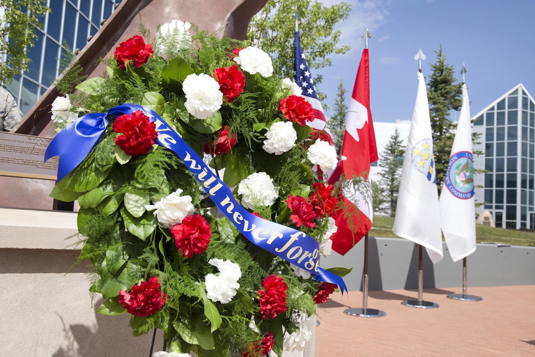A memorial wreath sits in front of the North American Aerospace Defense Command and U.S. Northern Command memorial
