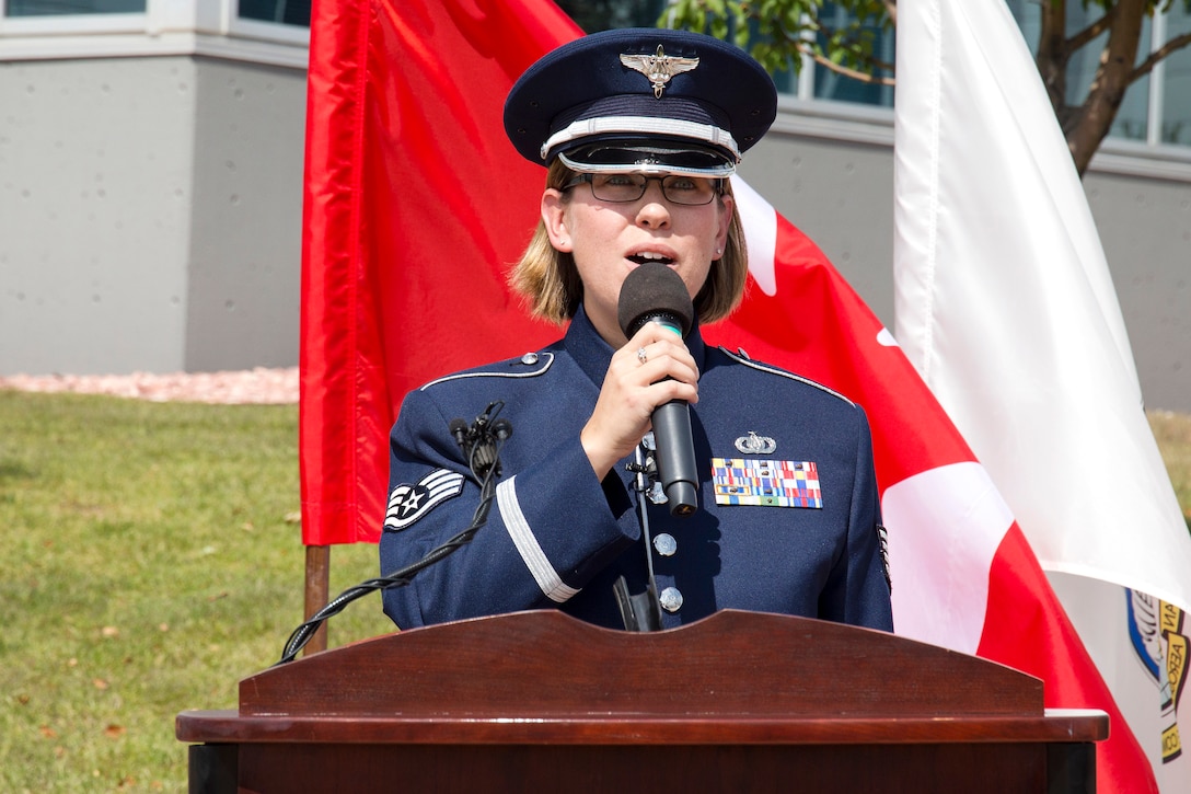 Air Force Staff Sgt. Rachel Wilson sings both the American and Canadian national anthems at the beginning of a remembrance ceremony