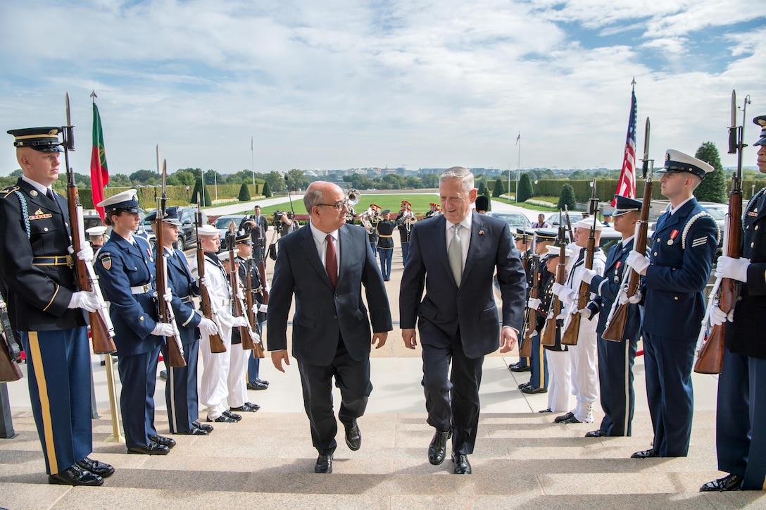 Defense Secretary Jim Mattis walks up the steps with the Portuguese defense minister.