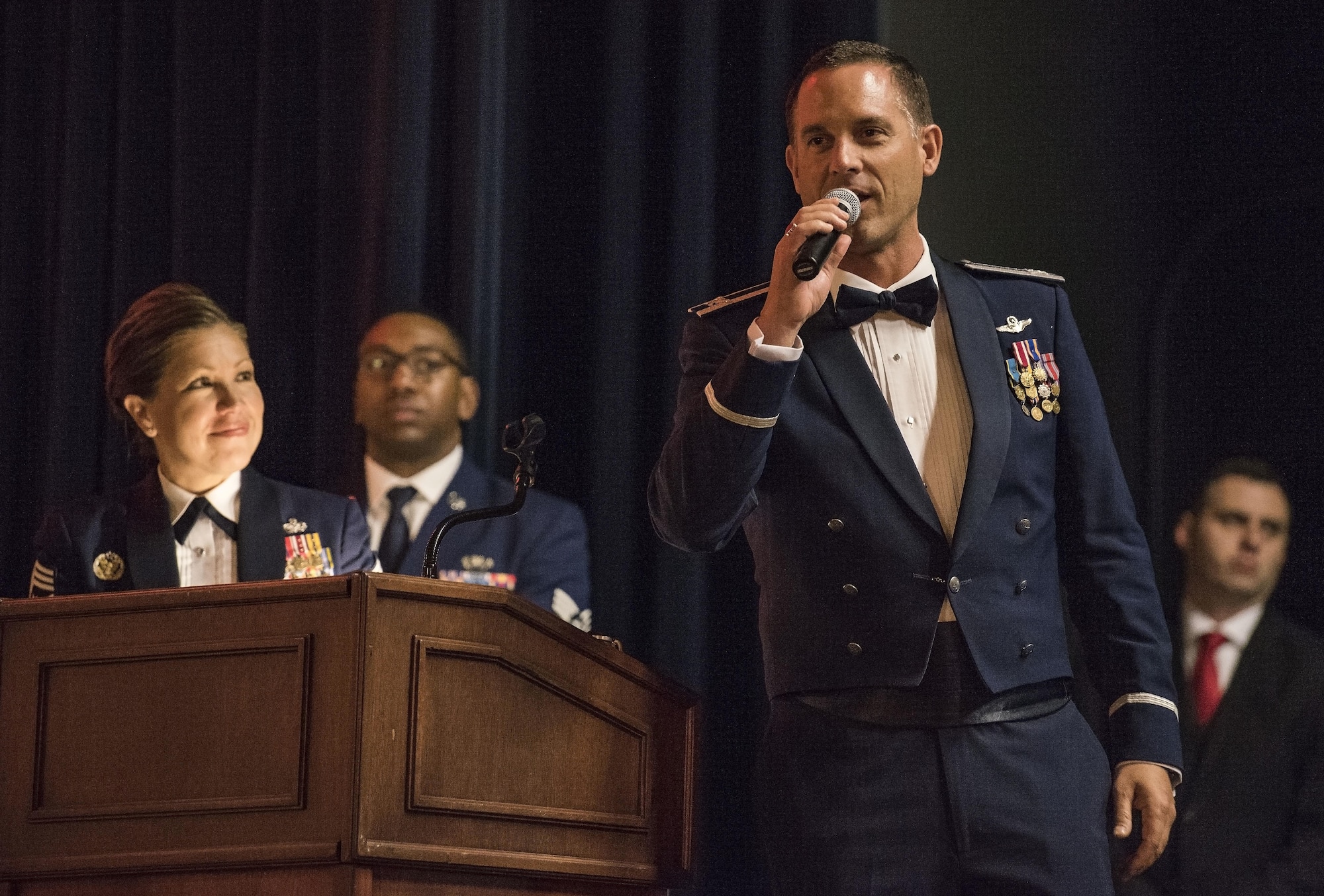 Col. Ethan Griffin, 436th Airlift Wing commander, right, makes closing remarks to “Wings Over Dover,” 70th Anniversary Air Force Ball attendees as Chief Master Sgt. Sarah Sparks, 436th AW command chief, left, looks on Sept. 8, 2017, at the Rollins Center, Dover Downs Hotel and Casino, Dover, Del. Griffin thanked all for attending, committee members, sponsors, and community members for making the gala-style event a success. (U.S. Air Force photo by Roland Balik)