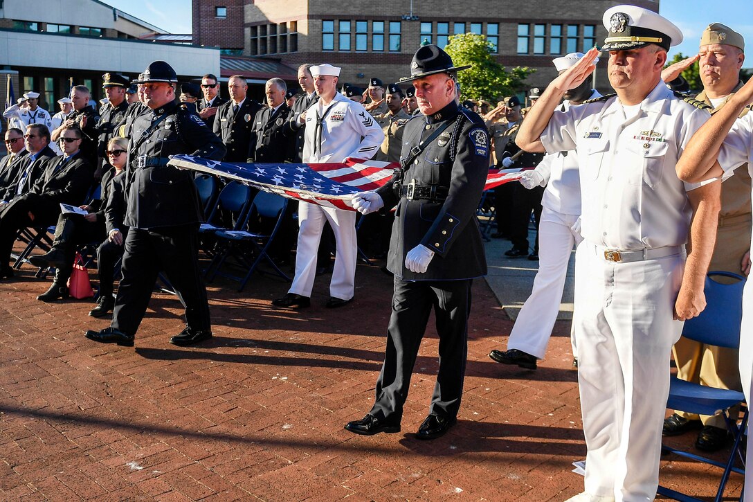 Sailors and members of the South Snohomish County Police Honor Guard conduct color guard honors during a 9/11 remembrance ceremony