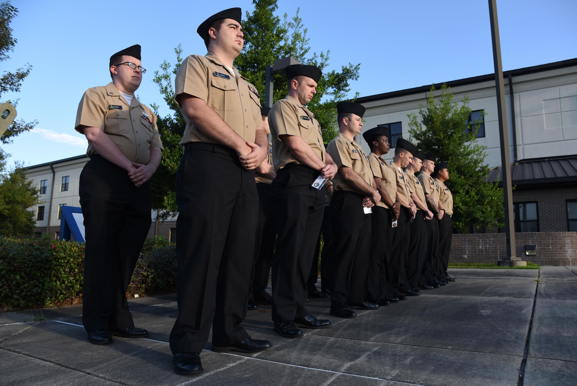 Members of the Center for Naval Aviation Technical Training Unit Keesler stand in formation during a 9/11 memorial ceremony hosted by the CNATTU Keesler in front of Alho Manor Sept. 11, 2017, on Keesler Air Force Base, Mississippi. The event honored those who lost their lives during the 9/11 attacks. (U.S. Air Force photo by Kemberly Groue)