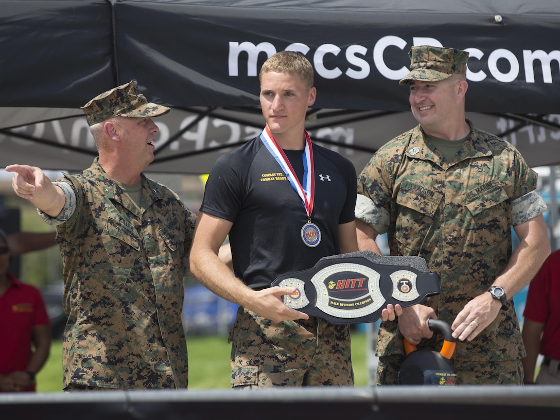 U.S. Marine Corps Sgt. Ethan Mawhinney receives an award from Brig. Gen. Kevin Killea and Sgt. Maj. Shawn Isaacson for winning High Intensity Tactical Training Tactical Athlete Competition’s Male Division at Paige Field House on Camp Pendleton, Calif., Aug. 31, 2017.  Mawhinney has participated in all three years of the HITT Tactical Athlete Competition, taking 1st place the past two years. (U.S. Marine Corps photo by Lance Cpl. Brienne Collins Miller)