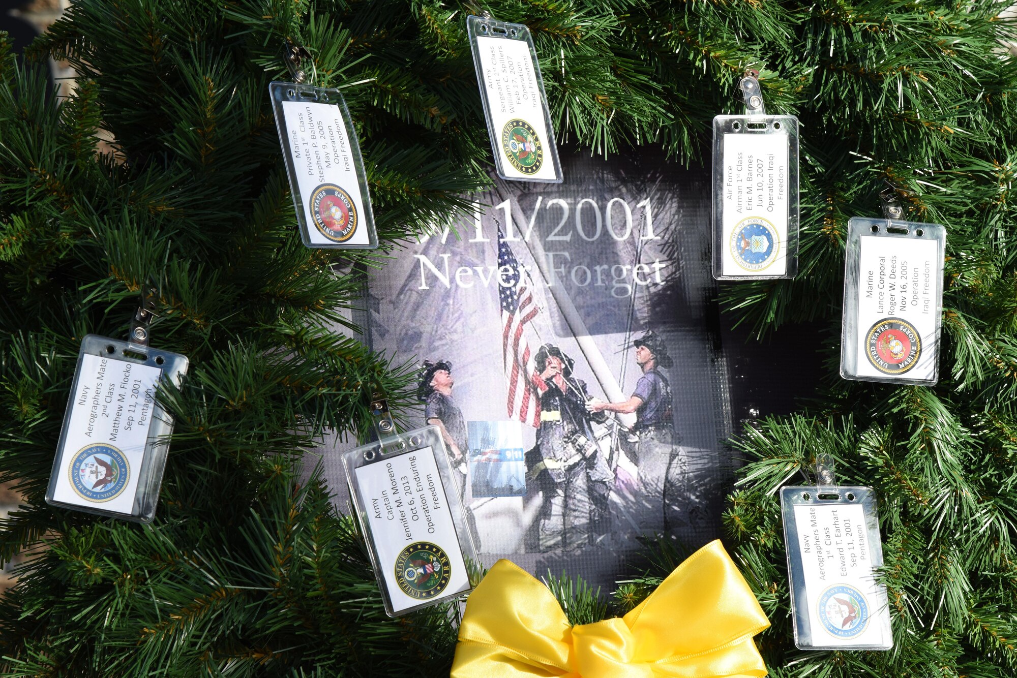 A wreath displaying names of military personnel who lost their lives in the 9/11 attacks sits on display during a 9/11 memorial ceremony hosted by the Center for Naval Aviation Technical Training Unit Keesler in front of Alho Manor Sept. 11, 2017, on Keesler Air Force Base, Mississippi. The event honored all those who lost their lives during the 9/11 attacks. (U.S. Air Force photo by Kemberly Groue)