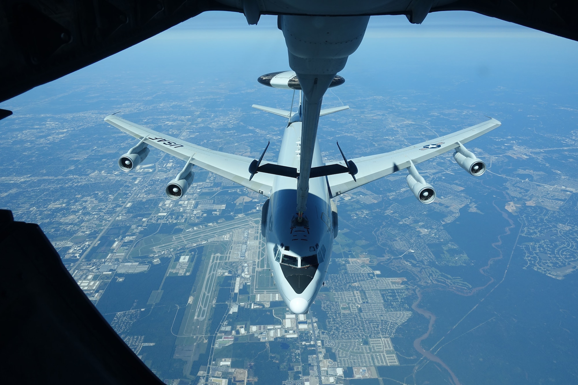 An Airborne Warning and Control System (AWACS) receives fuel from a KC-10 Extender operated by Airmen form the 76th Air Refueling Squadron while flying over flooded Houston, Texas. The AWACS operates as an aerial command post and radar tower in times of crisis.