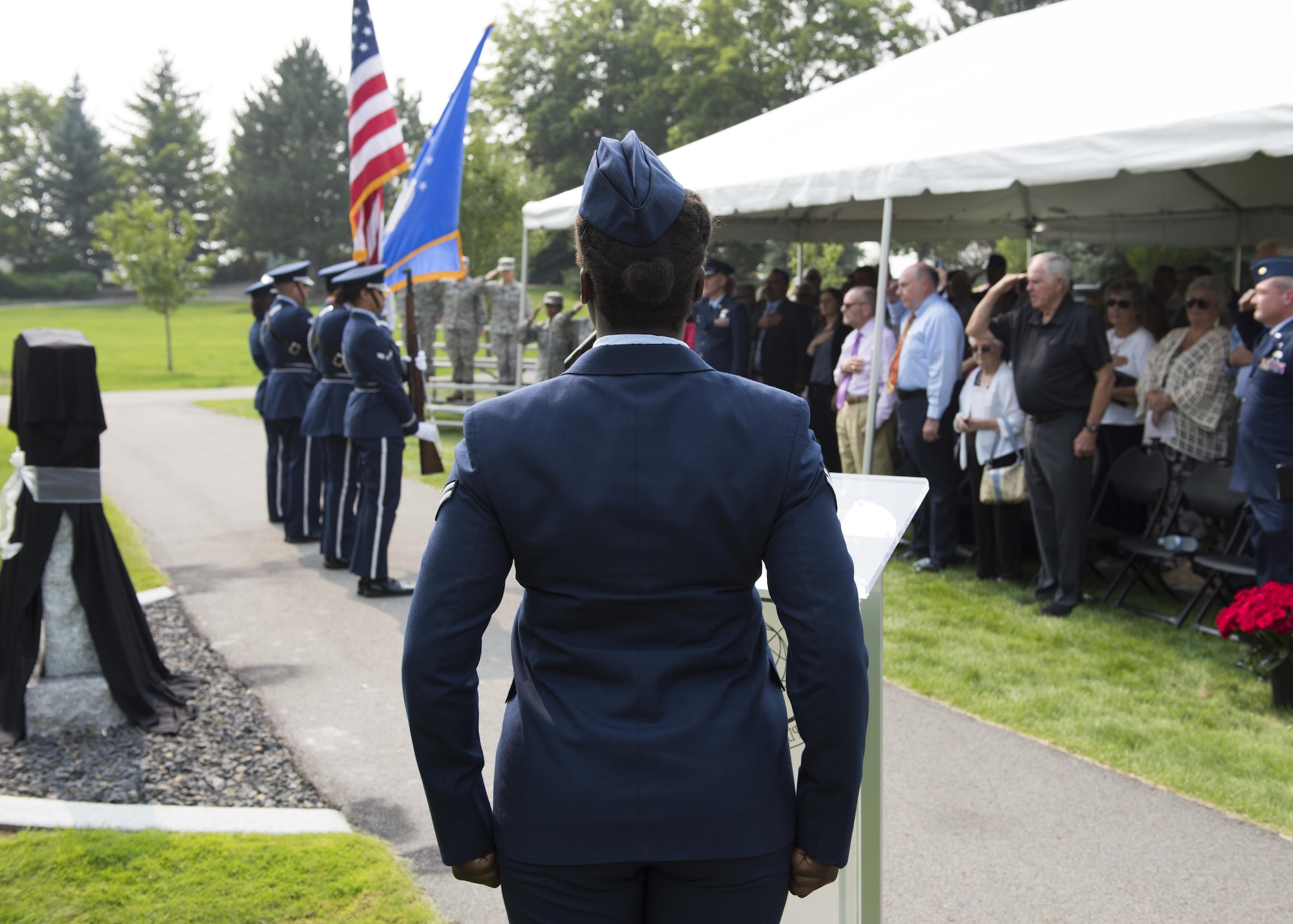 Airman 1st Class Mary Dunkley, 92nd Maintenance Squadron fuels technician, sings the national an-them at the start of a memorial dedication ceremony at Fairchild Air Force Base, Washington, Sept. 8, 2017. The memorial honors the memory of Airmen lost to a mid-air collision of two B-52 Stratofor-tresses near the base 59 years ago. (U.S. Air Force Photo by Airman 1st Class Ryan Lackey)