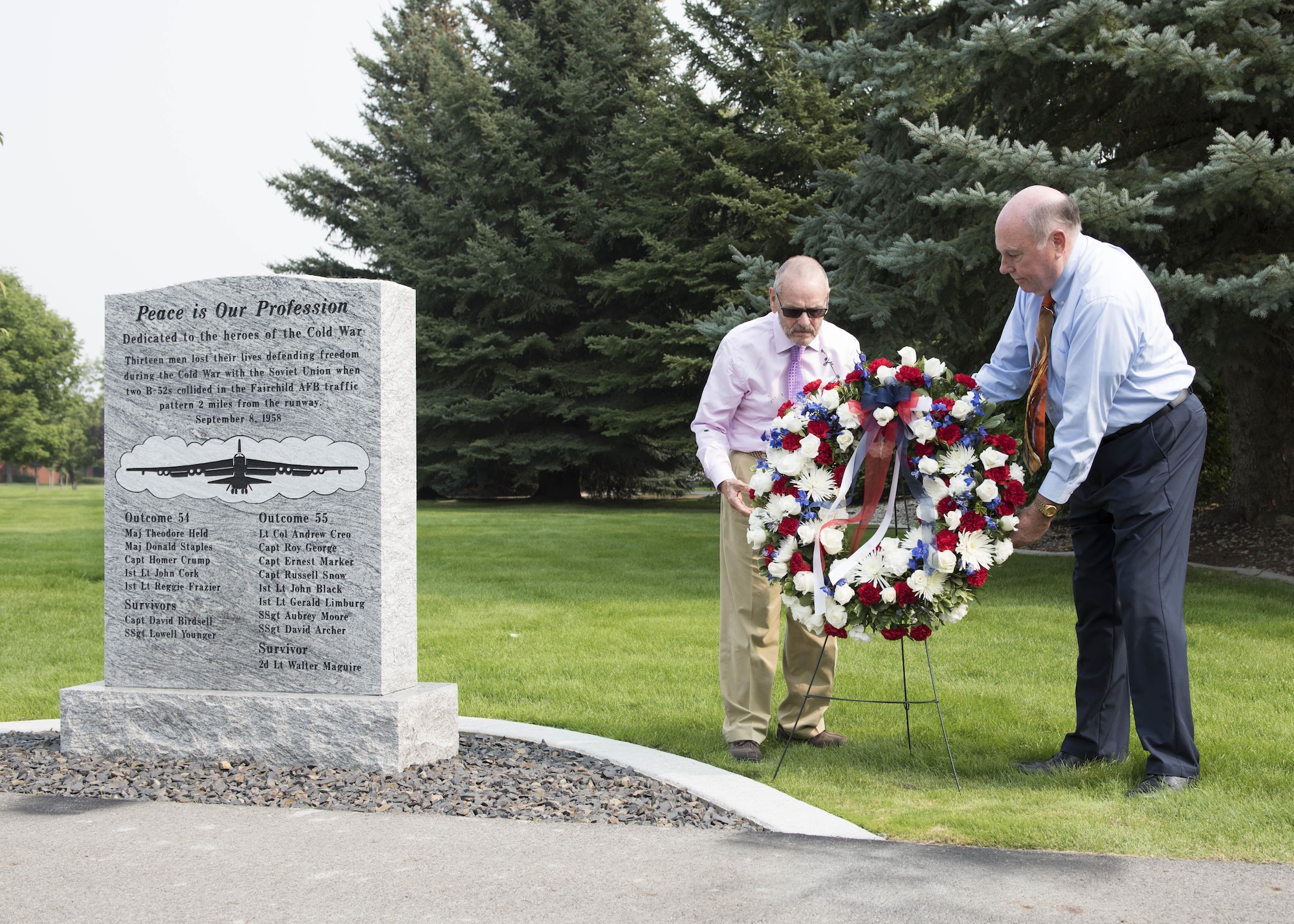 Mr. Larry Frazier (left) and Mr. Greg Staples (right), place a wreath next to the newly unveiled B-52 Stratofortress bomber memorial at Fairchild Air Force Base, Washington, Sept. 8, 2017. Frazier and Sta-ples both lost family to the B-52 crash in 1958, so they worked with base leaders to remember their sacrifice with a monument at Fairchild Memorial Park. (U.S. Air Force Photo by Airman 1st Class Ryan Lackey)