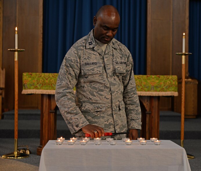 Capt. Sean Ballard, 47th Flying Training Wing chaplain, lights candles during a Patriot Day observance at the Chapel of the Wings at Laughlin Air Force Base, Texas, Sept. 11, 2017.  The candles represented 16 of the 2,978 victims whose biographies were read by the 47 FTW Chaplain Corps to observe 16 years since the attacks.