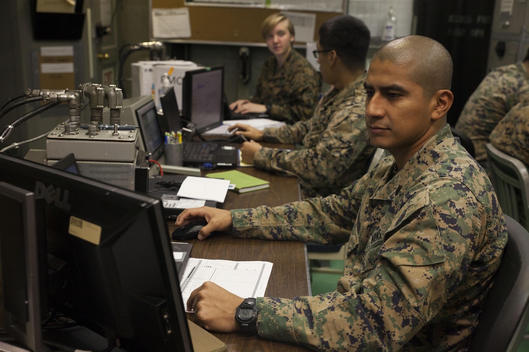 Staff Sgt. Jorge Estrada, a warehouse clerk with the 31st Marine Expeditionary Unit’s Tactical Logistics Group, reviews flight manifests aboard the USS Bonhomme Richard (LHD 6) while underway off the coast of Queensland, Australia, Aug. 20, 2017.