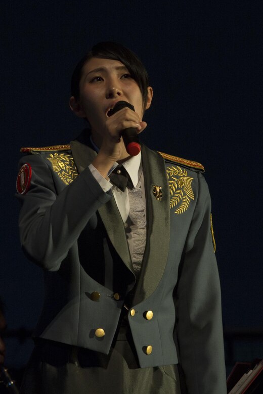 Leading Pvt. Kana Nakazawa sings during the 22nd Annual Combined Band Concert Sept. 9 at the Ginowan Civic Hall in Ginowan City, Okinawa, Japan.