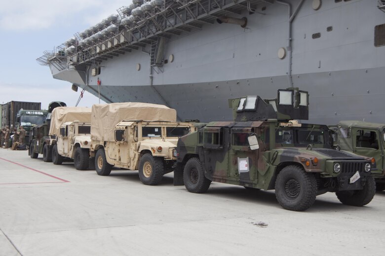 Humvees belonging to the 31st Marine Expeditionary Unit sit pier side at White Beach Naval Facility, Okinawa, Japan, June 7, 2017.