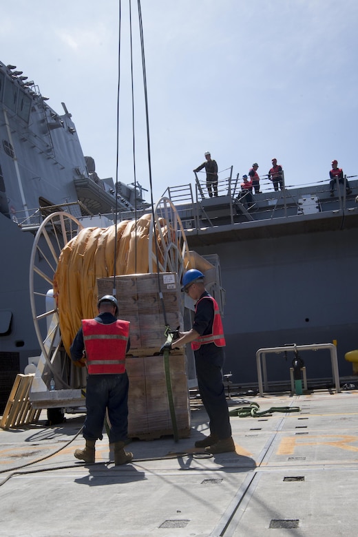 Marines with the 31st Marine Expeditionary Unit attach rations to a crane at White Beach Naval Facility, Okinawa, Japan, June 7, 2017.