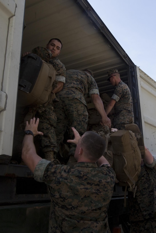 Marines with the 31st Marine Expeditionary Unit move sea bags, packs and gear pier side at White Beach Naval Facility, Okinawa, Japan, June 7, 2017.