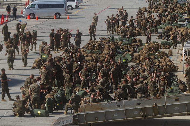 A mass of Marines, packs, sea bags and weapons sit pier side alongside the USS Bonhomme Richard (LHD 6) as the Marines and Sailors of the 31st Marine Expeditionary Unit embark aboard the BHR for a scheduled patrol of the Indo-Asia-Pacific region, June 7, 2017.