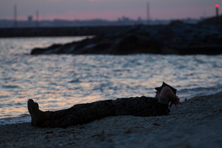 Petty Officer 3rd Class Matthew Robinson, a corpsman with Combat Logistics Battalion 31, enjoys a final sunset before departing from Okinawa, Japan, as part of the 31st Marine Expeditionary Unit, June 7, 2017.