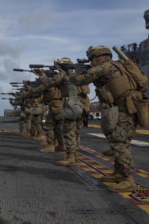 Marines with Kilo Company, Battalion Landing Team, 3rd Battalion, 5th Marines, conduct combat conditioning marksmanship training on the flight deck of the USS Bonhomme Richard (LHD 6) in the Pacific Ocean, June 24, 2017.