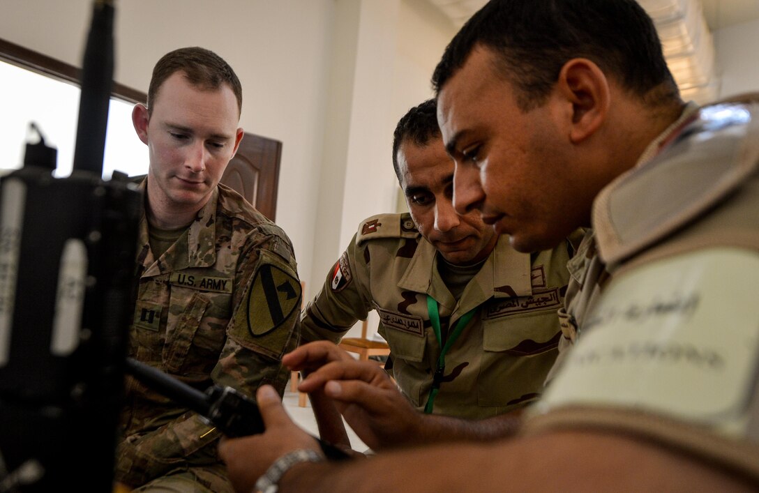 U.S. Army Capt. Brant Carstens, 2-7 U.S. Cavalry, 3rd Armored Brigade Combat Team, 1st Cavalry Division battalion signal officer, discusses radio operations with two Egyptian service members during a command-post exercise portion of Bright Star 2017, Sept. 10, 2017, at Mohamed Naguib Military Base, Egypt. Started in 1981, Bright Star builds on the strategic security relationship between the U.S. and Egypt, a partnership that supports counterterrorism, regional security, and efforts to combat the spread of violent extremism. (U.S. Air Force photo by Staff Sgt. Michael Battles)