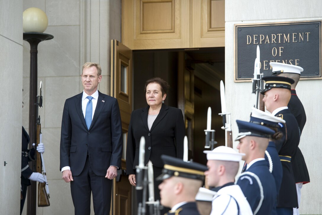 Two defense leaders stand together at the Pentagon.